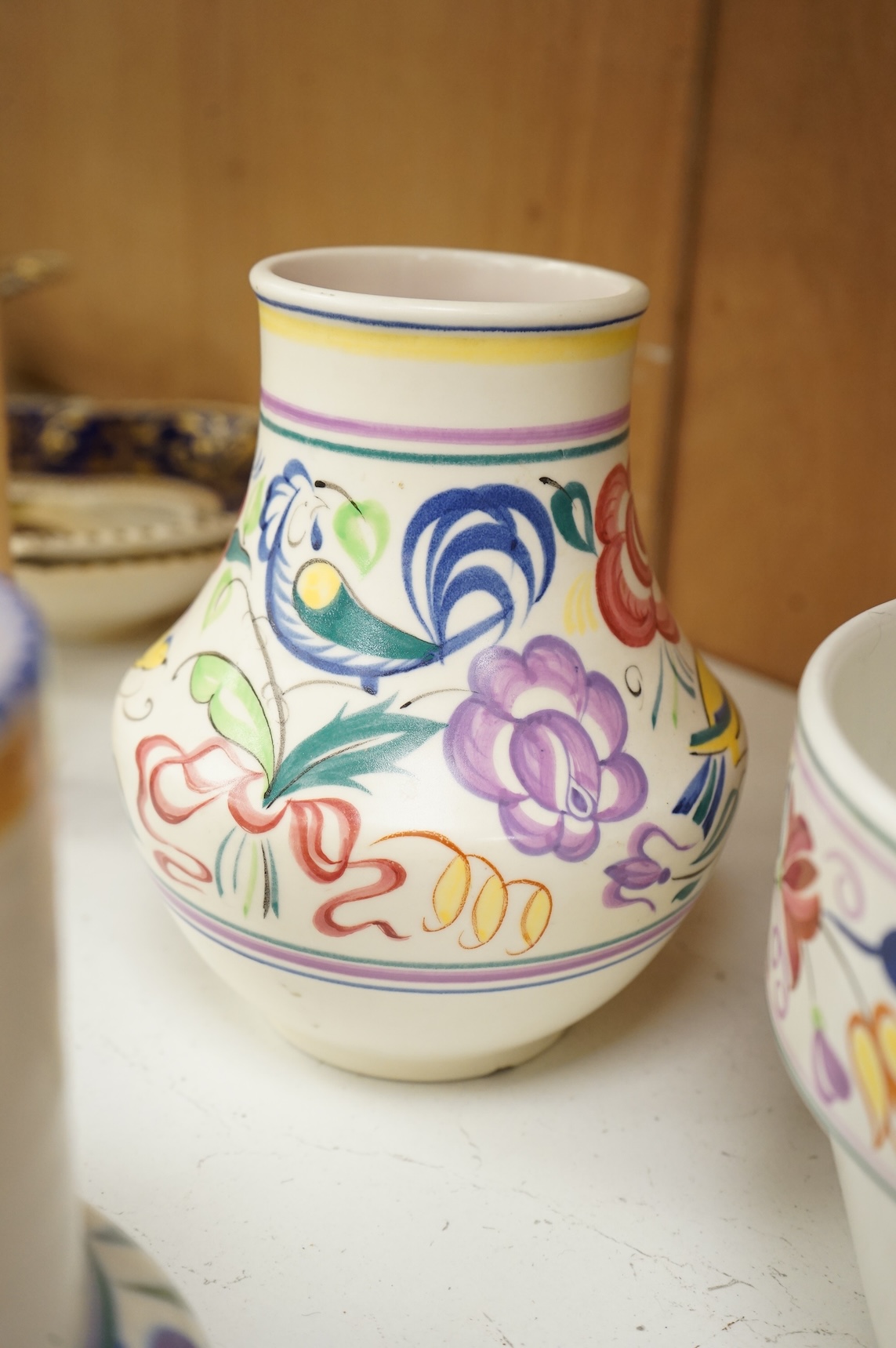 A collection of eight Poole pottery pieces to include vases, bowls and a jar and cover, largest 28cm in diameter